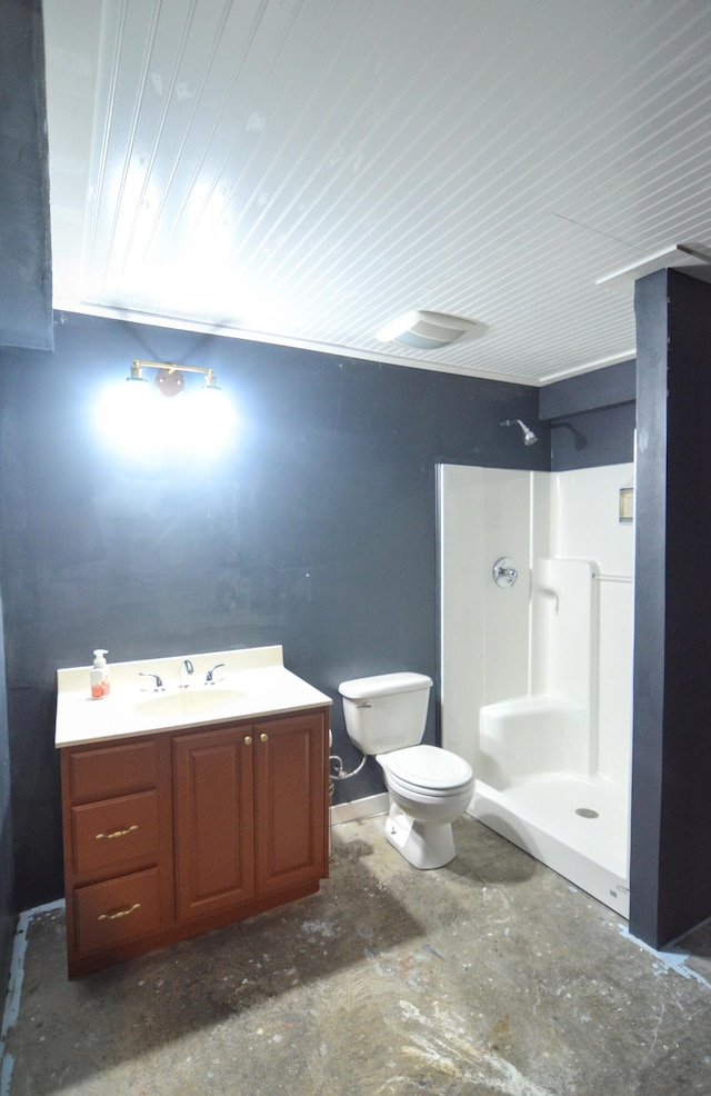 bathroom featuring vanity, walk in shower, and toilet