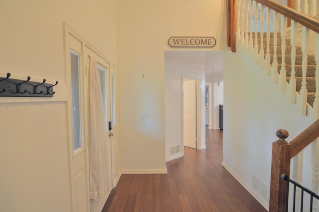 1376 Symbo Ln, Walton, KY 41094 - hallway featuring a towering ceiling, baseboards, visible vents, and dark wood-type flooring