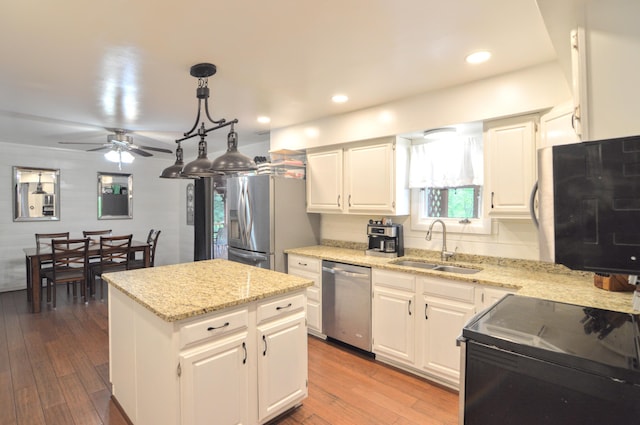 1376 Symbo Ln, Walton, KY 41094 - kitchen featuring a ceiling fan, appliances with stainless steel finishes, a center island, hardwood / wood-style flooring, and a sink