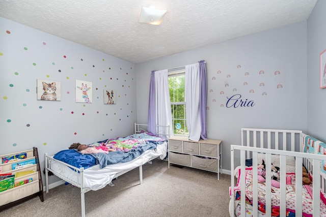bedroom with baseboards, a textured ceiling, and carpet