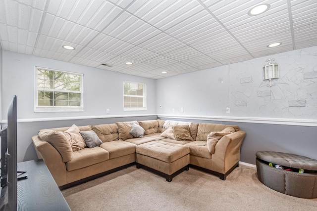 living room with recessed lighting, visible vents, and light colored carpet