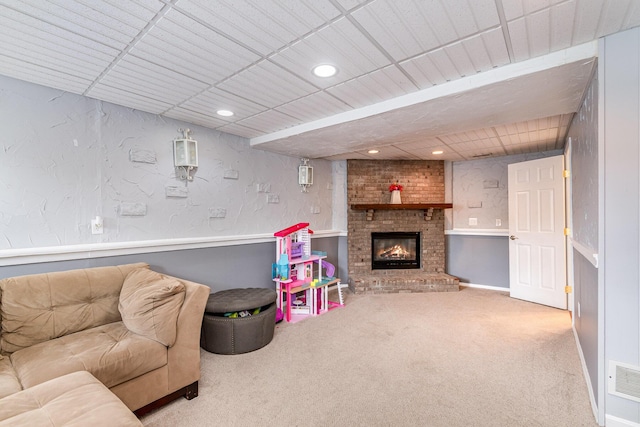 game room featuring visible vents, a brick fireplace, a textured wall, carpet flooring, and recessed lighting