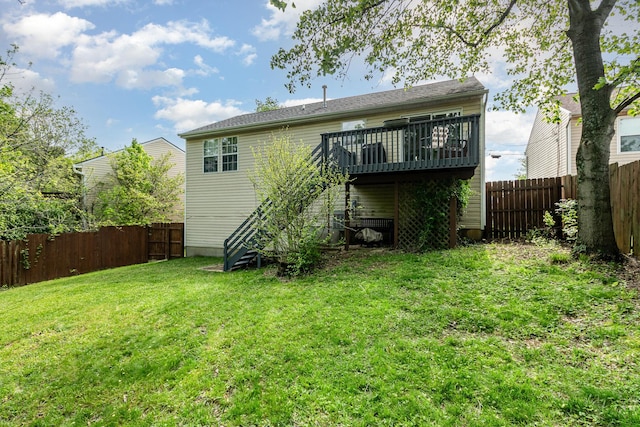 rear view of property featuring a fenced backyard, stairway, a yard, and a deck