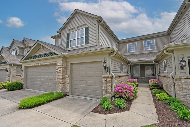 view of property with concrete driveway and brick siding