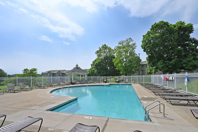 pool with fence, a gazebo, and a patio area