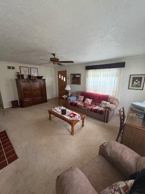 carpeted living room with a ceiling fan, a textured ceiling, and visible vents