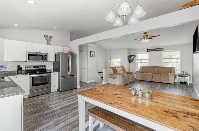 465 Eagle Creek Dr, Dry Ridge, KY 41035 - kitchen featuring vaulted ceiling, stainless steel appliances, white cabinetry, and decorative light fixtures