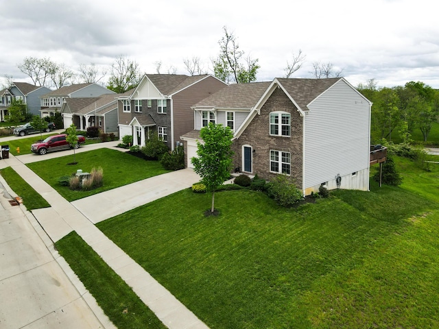 view of front of house with driveway, a front yard, a shingled roof, and a residential view