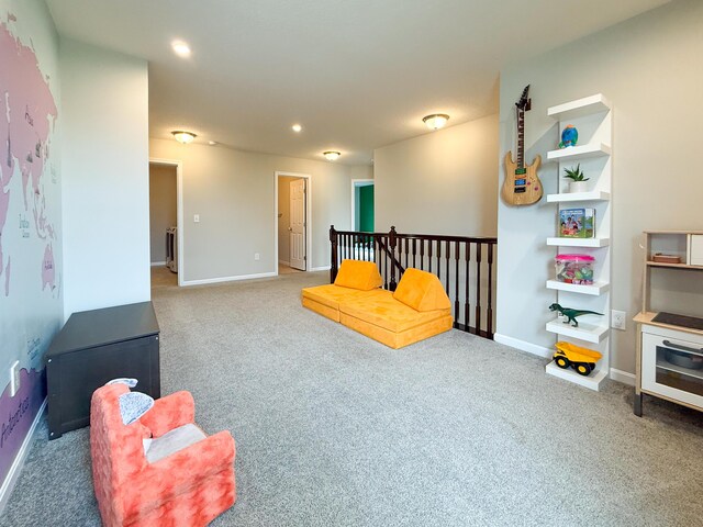 carpeted living area with recessed lighting and baseboards