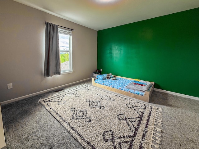 unfurnished bedroom featuring carpet and baseboards