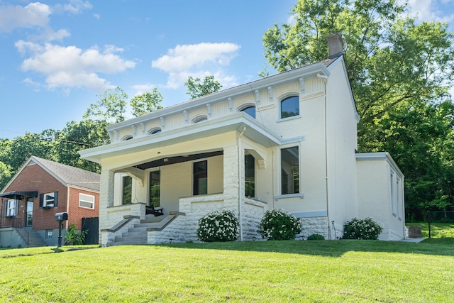 816 Highland Ave, Fort Wright, KY 41011 - italianate-style house featuring brick siding, a chimney, a front lawn, and covered porch