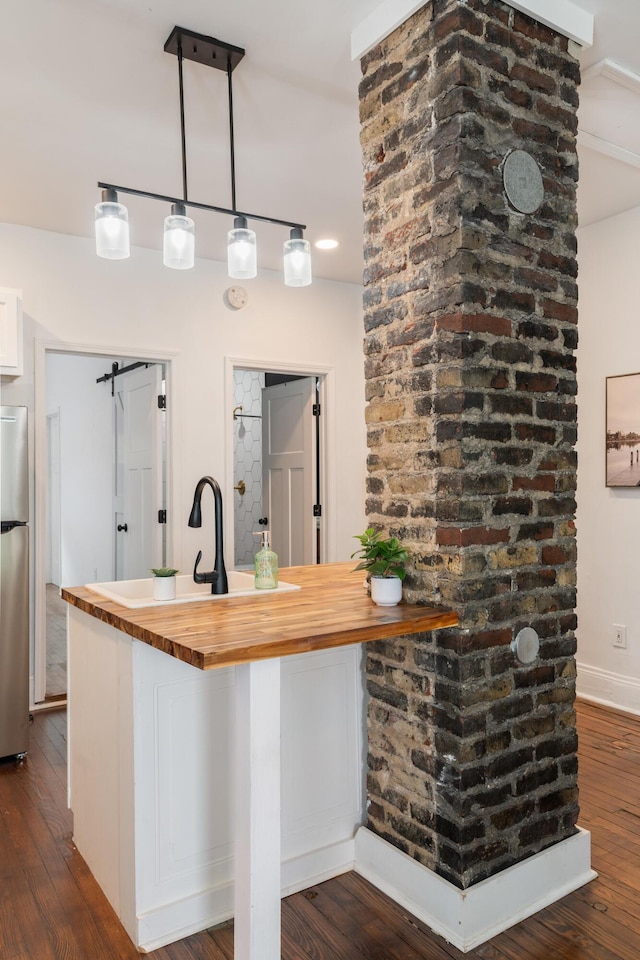 kitchen with freestanding refrigerator, dark wood-style flooring, and butcher block counters
