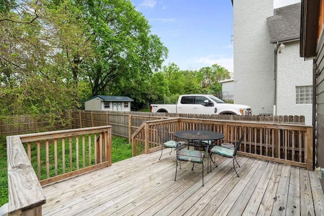 deck with outdoor dining area and a fenced backyard