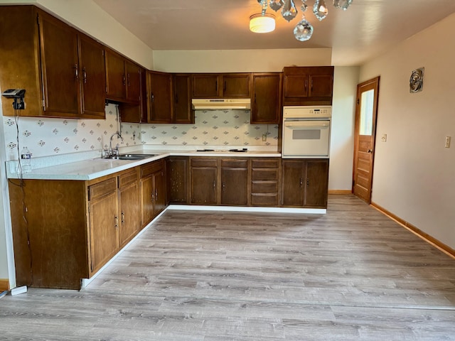 3390 Rector Rd, Morning View, KY 41063 - kitchen with under cabinet range hood, light wood finished floors, a sink, and white oven