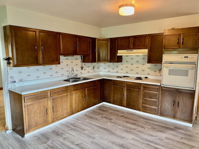3390 Rector Rd, Morning View, KY 41063 - kitchen featuring white appliances, light countertops, under cabinet range hood, a sink, and light wood-style flooring