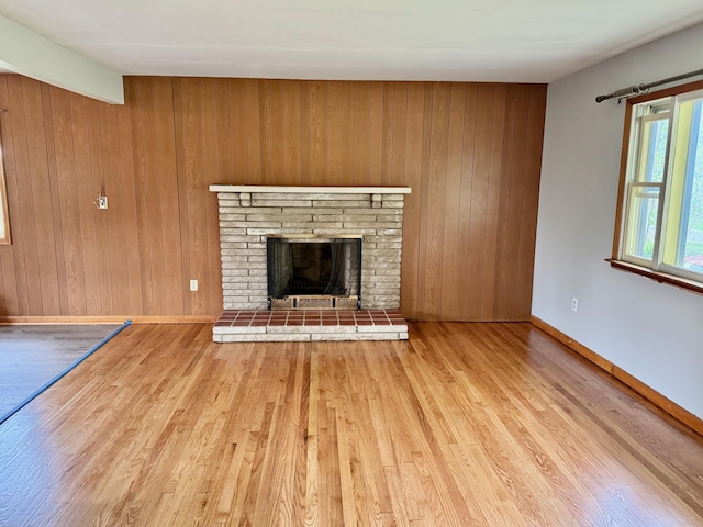 3390 Rector Rd, Morning View, KY 41063 - unfurnished living room with wooden walls, baseboards, a brick fireplace, and wood finished floors