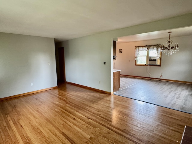 3390 Rector Rd, Morning View, KY 41063 - empty room featuring baseboards, an inviting chandelier, light wood finished floors, and cooling unit
