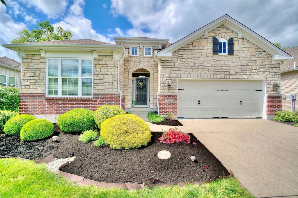 3909 Parkplace Dr, Erlanger, KY 41018 - view of front of home featuring stone siding, concrete driveway, and a garage