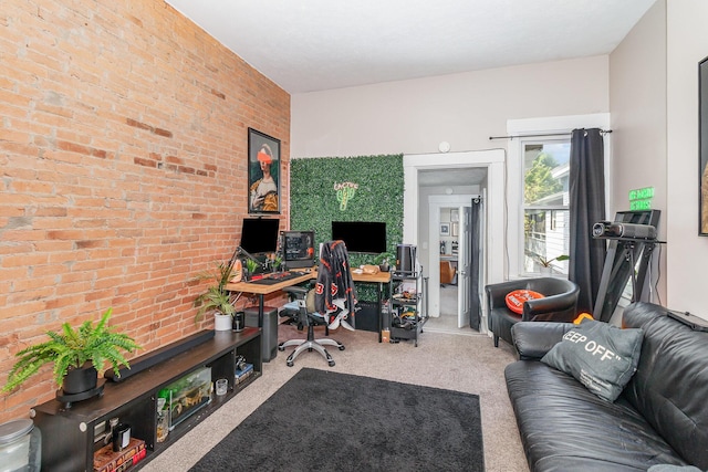 office with carpet floors and brick wall