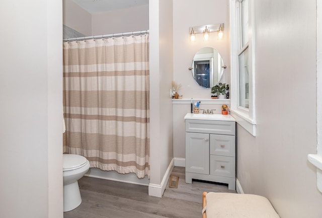 full bath with vanity, toilet, wood finished floors, and a shower with shower curtain