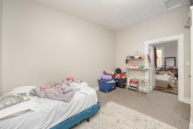 bedroom with baseboards and carpet