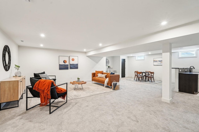 living room featuring light colored carpet, recessed lighting, and baseboards