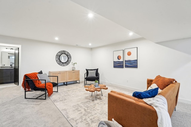 living room with recessed lighting, light carpet, and baseboards