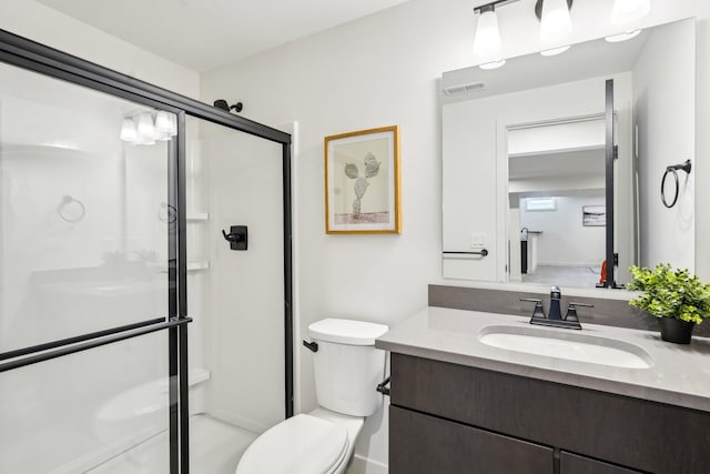 full bathroom featuring a stall shower, toilet, and vanity