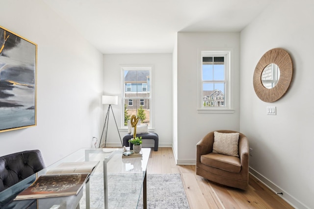 office space featuring light wood-type flooring and baseboards