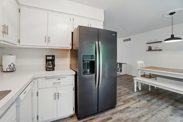 kitchen featuring stainless steel fridge with ice dispenser, wood finished floors, light countertops, white cabinets, and white dishwasher