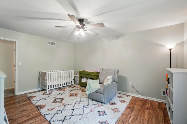 bedroom with wood finished floors, baseboards, and a ceiling fan