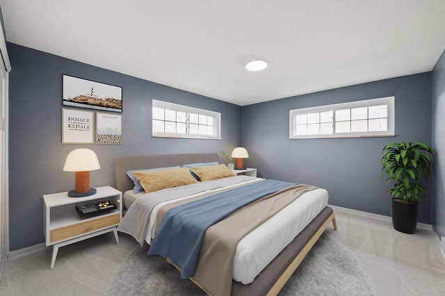 carpeted bedroom featuring multiple windows and baseboards