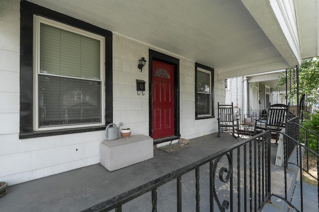view of exterior entry with a porch