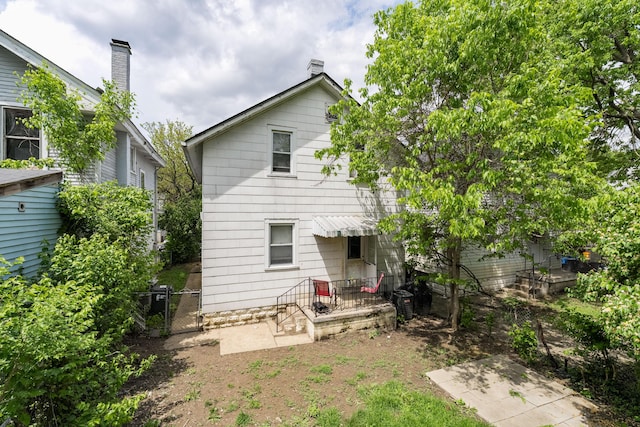 back of house with fence