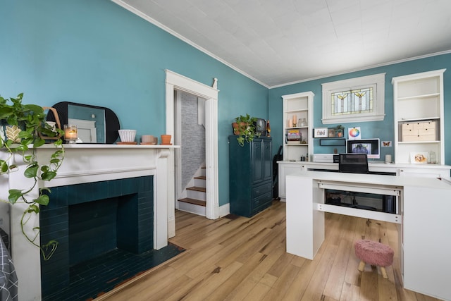 kitchen featuring open shelves, a brick fireplace, crown molding, light countertops, and light wood-style floors