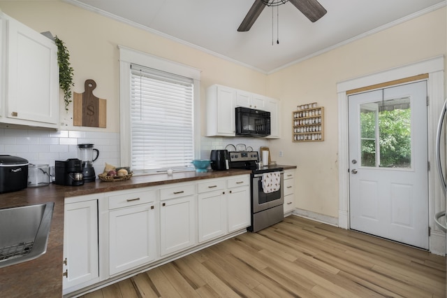 kitchen with black microwave, crown molding, stainless steel electric stove, and dark countertops
