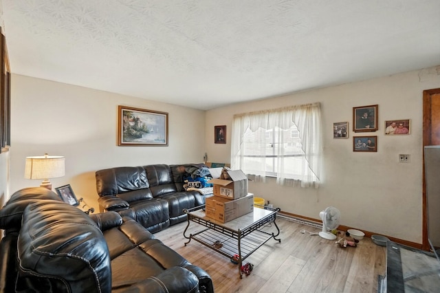 living area with light wood-style flooring and baseboards