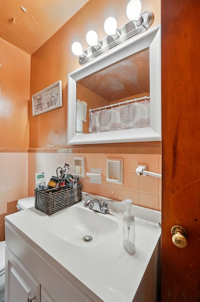full bath with vanity, tile walls, and toilet