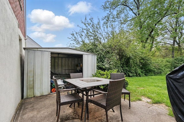 view of patio featuring a storage unit, an outdoor structure, and outdoor dining area