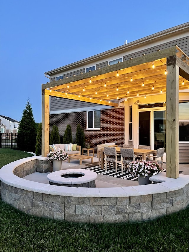 view of patio with a fire pit and fence