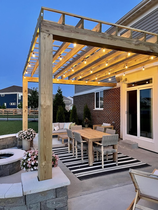 view of patio / terrace featuring outdoor dining area, fence, a pergola, and an outdoor fire pit