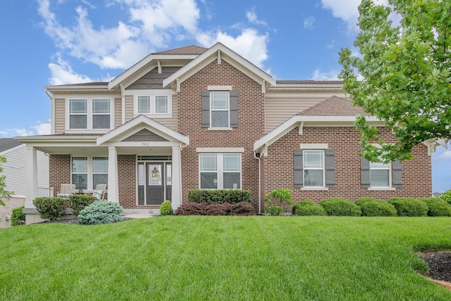 craftsman house with brick siding and a front lawn