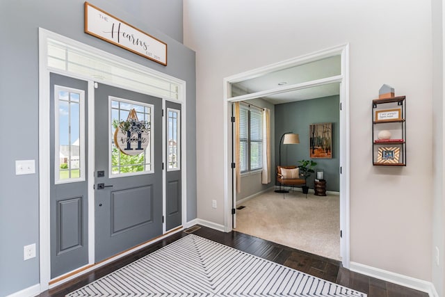 entryway with dark wood-style floors and baseboards