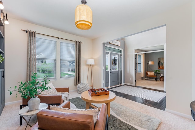 living area featuring carpet and baseboards