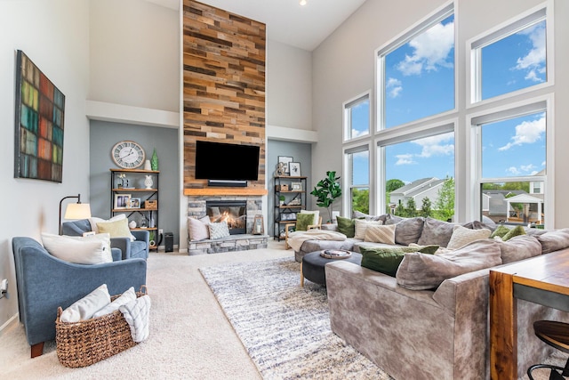 living room with carpet flooring, a towering ceiling, a fireplace, and baseboards