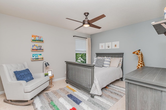 carpeted bedroom with ceiling fan and baseboards