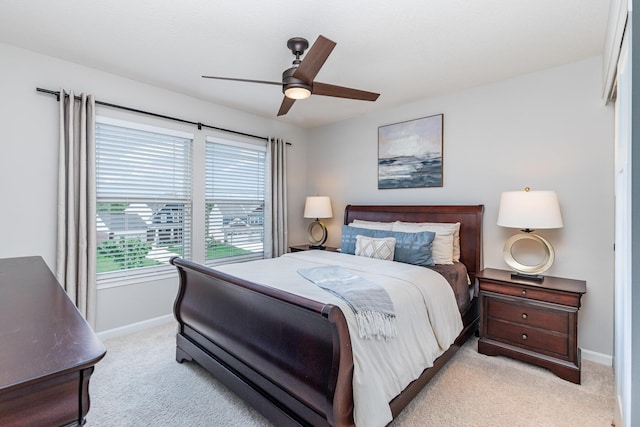 bedroom with light carpet, baseboards, and ceiling fan