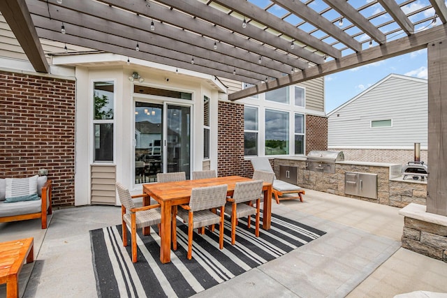 view of patio with area for grilling, exterior kitchen, a pergola, and outdoor dining space