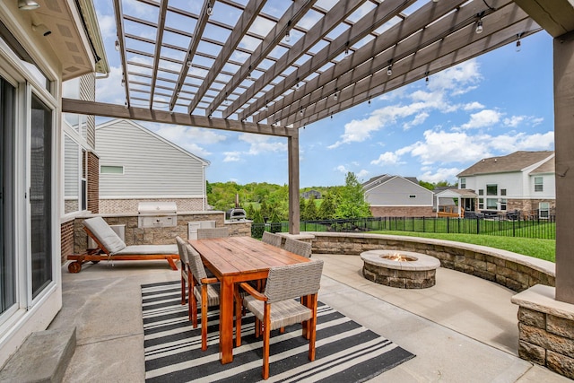 view of patio / terrace featuring a fire pit, an outdoor kitchen, a pergola, area for grilling, and outdoor dining area