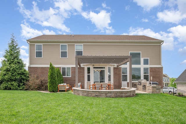rear view of house featuring exterior kitchen, a pergola, brick siding, and a patio